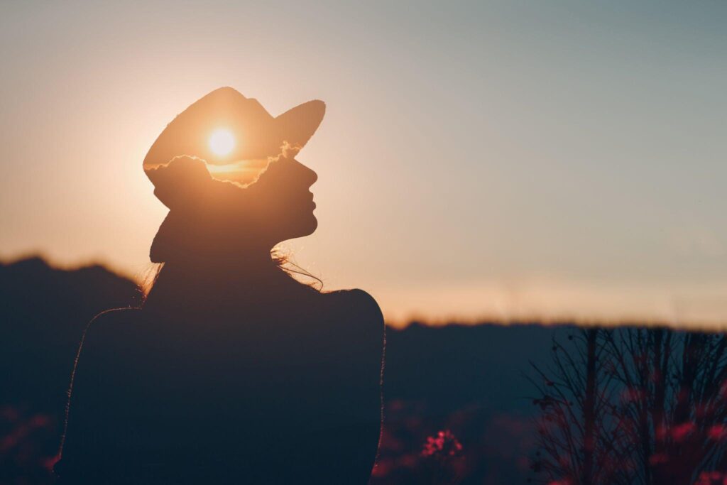 An individual staring at the sky, thinking deeply