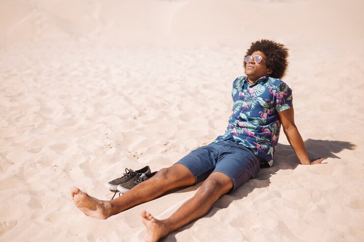 A guy soaking up the sun on a beach