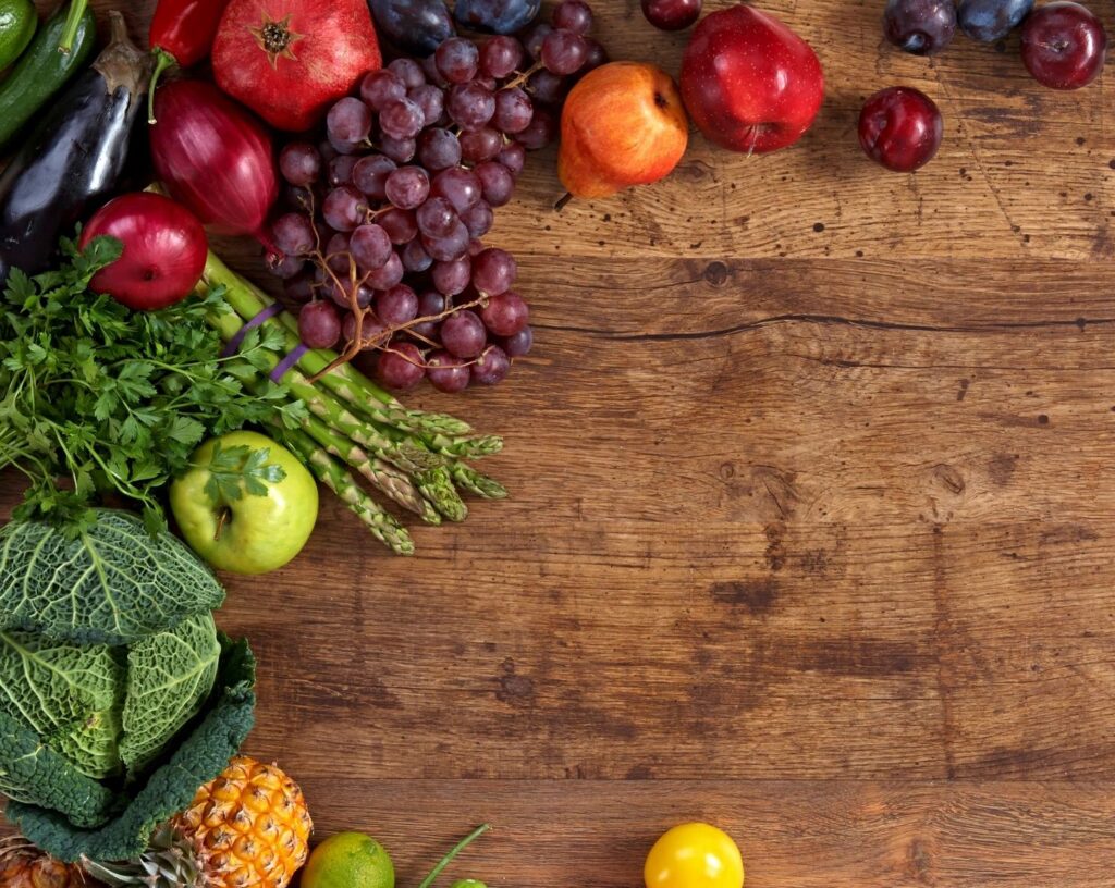 Wooden serving board with fruits and vegetables