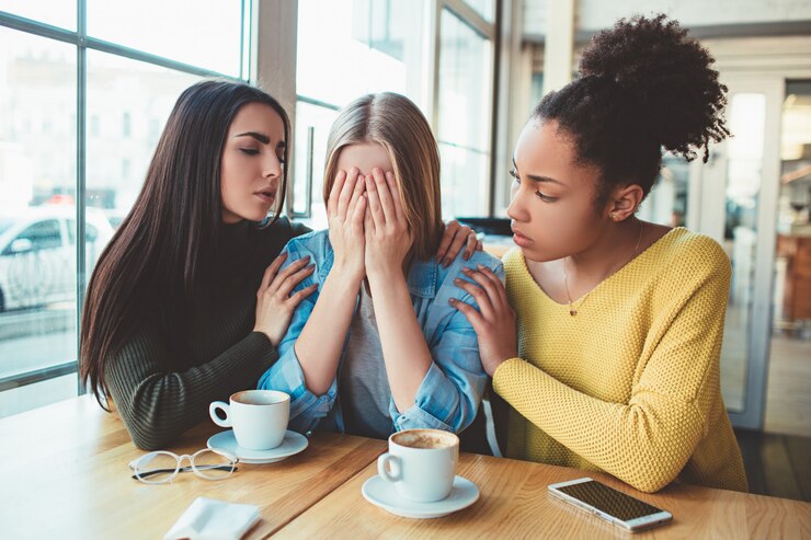 lady being consoled by her friends