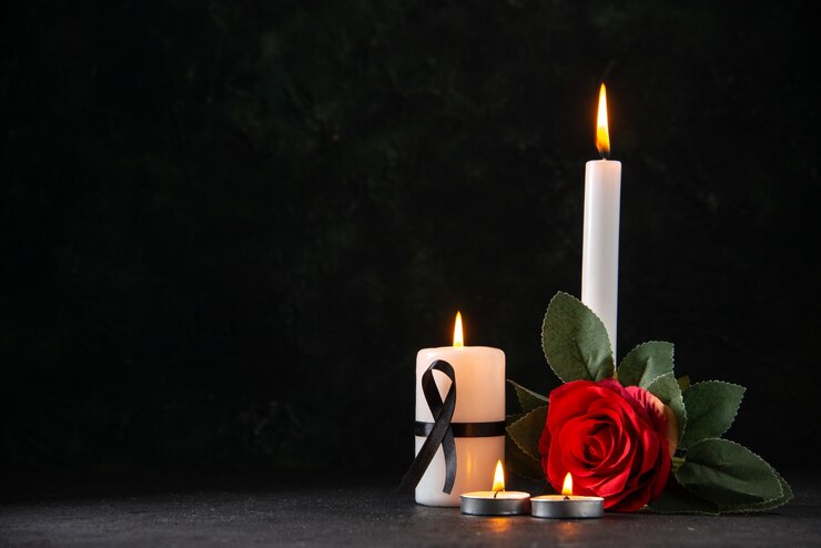 a memorial representation consisting of candles and flowers