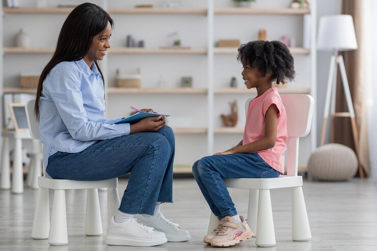 child psychotherapist having conversation with a little girl