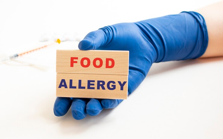 mini wooden board with the inscription of the words- food allergy