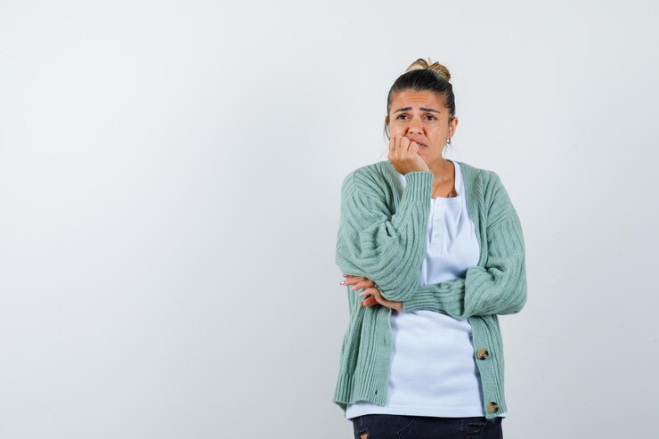 young lady leaning chin on hand looking anxious