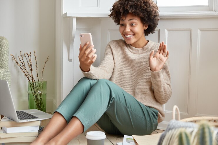 A lady excited to video call her friends