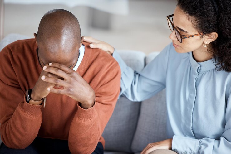 African American male individual being supported by a young lady