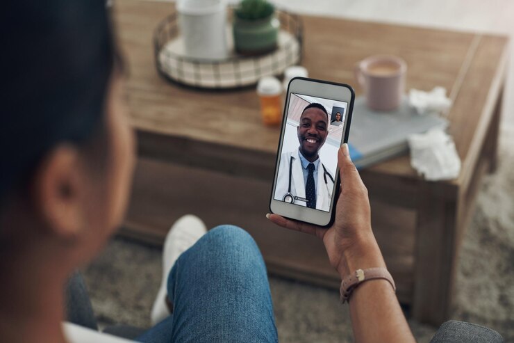 An individual on a video call with his doctor