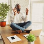 a man doing yoga before resuming working