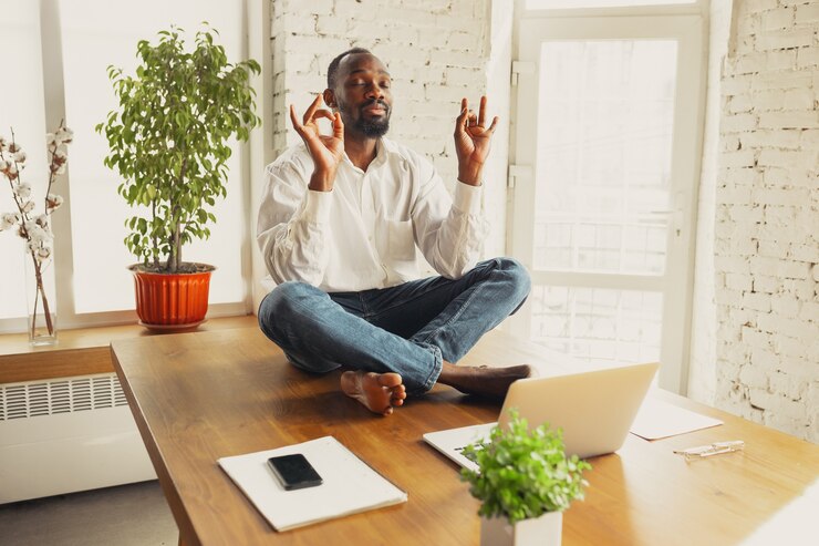 a man doing yoga before resuming working