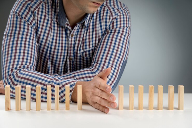 a man uses his hand and wooden blocks to illustrate boundaries