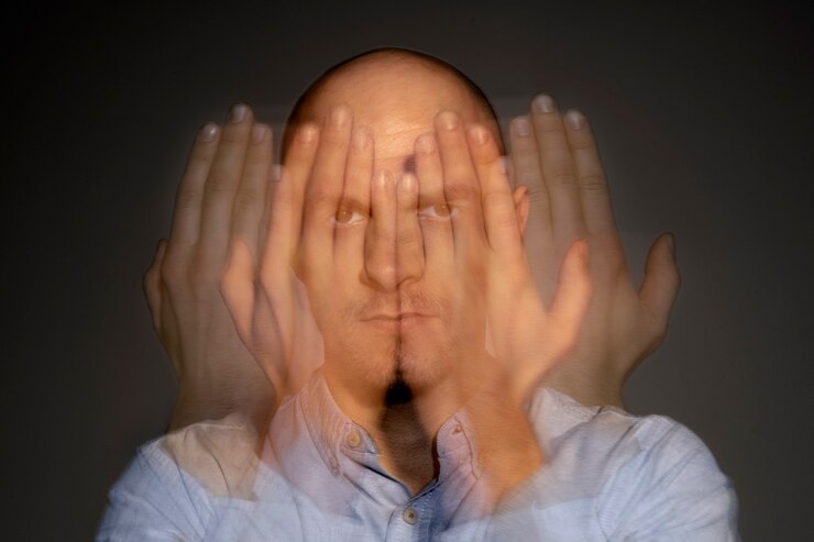 portrait of man seeing multiple pictures of his hand