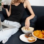 woman with three different plates of food for donuts, crisps and popcorns